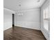 Elegant dining room featuring paneled walls, wood floors, and a chandelier, perfect for entertaining guests at 3717 Blue Goose Ln, Loganville, GA 30052