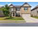 Charming two-story home with a well-manicured lawn, stone accents, and an attached two-car garage at 3717 Blue Goose Ln, Loganville, GA 30052