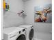 Convenient laundry room featuring modern washer and dryer and storage shelving at 3717 Blue Goose Ln, Loganville, GA 30052