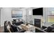 Elegant living room with fireplace, large TV, and sophisticated decor at 3717 Blue Goose Ln, Loganville, GA 30052