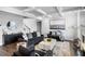 Modern living room boasts coffered ceilings, dark furniture, and stylish decor at 3717 Blue Goose Ln, Loganville, GA 30052