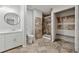 Bathroom showcasing a glass shower, built-in closet, and neutral-toned tile flooring at 3753 Eli Dr, Snellville, GA 30039