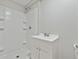 Clean white bathroom features a single sink vanity and a shower-tub combo at 3753 Eli Dr, Snellville, GA 30039
