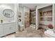 Bathroom showcasing a glass shower, built-in closet, and neutral-toned tile flooring at 3753 Eli Dr, Snellville, GA 30039
