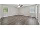 Airy bedroom boasting two windows and ceiling fan at 3753 Eli Dr, Snellville, GA 30039