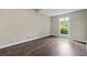 Inviting bedroom features sleek wood flooring and a bright window overlooking a leafy exterior at 3753 Eli Dr, Snellville, GA 30039