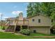 A charming home featuring a spacious deck, set on a lush lawn, with an inviting outdoor living space at 3753 Eli Dr, Snellville, GA 30039