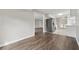 Open-concept kitchen with stainless steel refrigerator, white cabinetry, and sleek wood flooring at 3753 Eli Dr, Snellville, GA 30039