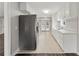 Modern kitchen with stainless steel refrigerator, white cabinetry, and stylish tile flooring at 3753 Eli Dr, Snellville, GA 30039