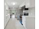Bright kitchen features white cabinets and stainless steel appliances at 3753 Eli Dr, Snellville, GA 30039