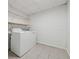 Bright laundry room with washer, dryer, and shelving at 3753 Eli Dr, Snellville, GA 30039