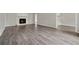 Spacious living room boasts a charming fireplace and stylish wood flooring, creating a cozy and inviting atmosphere at 3753 Eli Dr, Snellville, GA 30039