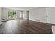 Bright living room featuring wood flooring, a front door, and a large window providing ample natural light at 3753 Eli Dr, Snellville, GA 30039