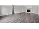 Bright living room features a cozy fireplace and sleek wood flooring, enhancing its modern and inviting design at 3753 Eli Dr, Snellville, GA 30039