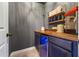 Wet bar area featuring custom cabinetry, countertop space, and under-counter refrigerator at 3952 Dragon Fly Ln, Loganville, GA 30052