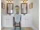 Dual sink bathroom vanity featuring plenty of lighting and mirrors at 3952 Dragon Fly Ln, Loganville, GA 30052