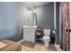 Bathroom with neutral walls, decorative mirror, a toilet, and a tiled floor at 3952 Dragon Fly Ln, Loganville, GA 30052
