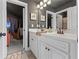 Updated bathroom features double sinks, neutral walls and floors, and decorative mirrors at 3952 Dragon Fly Ln, Loganville, GA 30052