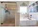 Bright bathroom featuring a tile shower, large soaking tub, neutral tones and decorative touches for a spa-like feel at 3952 Dragon Fly Ln, Loganville, GA 30052