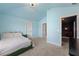 Airy bedroom with pale blue walls, plush carpet and a view into the movie room at 3952 Dragon Fly Ln, Loganville, GA 30052