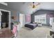 Cozy bedroom features plush carpet, sloped ceilings, a ceiling fan, and natural light from the window at 3952 Dragon Fly Ln, Loganville, GA 30052