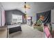 Comfortable bedroom with large window, plush carpet, and a ceiling fan, perfect for relaxing at 3952 Dragon Fly Ln, Loganville, GA 30052
