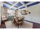 Formal dining room featuring a blue coffered ceiling, chandelier, and ample natural light at 3952 Dragon Fly Ln, Loganville, GA 30052