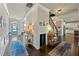 Grand foyer with hardwood floors, elegant lighting, and a charming blue front door provides a warm welcome at 3952 Dragon Fly Ln, Loganville, GA 30052