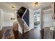 Inviting foyer with dark hardwood floors, a staircase, and views into the dining room at 3952 Dragon Fly Ln, Loganville, GA 30052