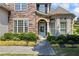Charming front entrance with a light blue door, stone accents, and beautiful landscaping at 3952 Dragon Fly Ln, Loganville, GA 30052