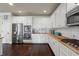 Bright kitchen features stainless steel appliances, granite countertops, white cabinets, and modern fixtures at 3952 Dragon Fly Ln, Loganville, GA 30052