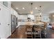 Modern kitchen boasts an island with seating, pendant lights, stainless steel appliances, and ample counter space at 3952 Dragon Fly Ln, Loganville, GA 30052
