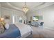 Relaxing main bedroom with plush carpeting and tray ceilings at 3952 Dragon Fly Ln, Loganville, GA 30052