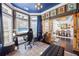 Comfortable home office featuring a blue coffered ceiling and views of the dining room at 3952 Dragon Fly Ln, Loganville, GA 30052