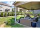 This home boasts a large covered patio with comfortable seating, providing a relaxing outdoor space with a backyard view at 3952 Dragon Fly Ln, Loganville, GA 30052
