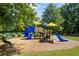 Community playground with slides, climbing structures, and benches, surrounded by lush green trees and well-maintained landscaping at 3952 Dragon Fly Ln, Loganville, GA 30052