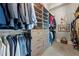 Spacious walk-in closet featuring custom shelving, hanging rods, and drawer storage at 3952 Dragon Fly Ln, Loganville, GA 30052