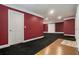 Finished basement area with new carpeting, trim and red accent walls at 1105 Tom Lane Ln, Marietta, GA 30066