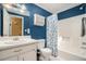 Bathroom featuring a vanity, toilet, and shower/tub combo with floral shower curtain at 1105 Tom Lane Ln, Marietta, GA 30066