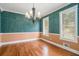 Formal dining room with hardwood floors and textured teal and tan paint, a great place to entertain at 1105 Tom Lane Ln, Marietta, GA 30066