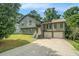 Charming two-story home featuring an attached two-car garage and lush landscaping at 1105 Tom Lane Ln, Marietta, GA 30066