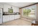 The bright kitchen features white cabinets, tile flooring, and stainless appliances at 1105 Tom Lane Ln, Marietta, GA 30066