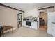Cozy kitchen with tile floor, access to dining and living room, white cabinets and modern appliances at 1105 Tom Lane Ln, Marietta, GA 30066