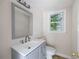 Bright bathroom features a gray vanity, modern fixtures, and a window at 255 Jade Cove Dr, Roswell, GA 30075