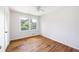 Bright bedroom with hardwood floors and a large window overlooking lush greenery at 255 Jade Cove Dr, Roswell, GA 30075