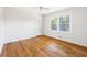 Cozy bedroom with a ceiling fan, closet, and a window overlooking the trees at 255 Jade Cove Dr, Roswell, GA 30075