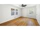 Well-lit bedroom with hardwood floors and windows offering views of the trees at 255 Jade Cove Dr, Roswell, GA 30075