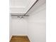 Walk-in closet with hardwood floors, a clothing rod, and built-in shelving at 255 Jade Cove Dr, Roswell, GA 30075