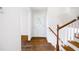 Bright foyer featuring hardwood floors and staircase, creating a warm welcome into the home at 255 Jade Cove Dr, Roswell, GA 30075