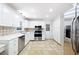 Spacious kitchen with white cabinets, stainless steel appliances, tile floors, and lots of natural light at 255 Jade Cove Dr, Roswell, GA 30075